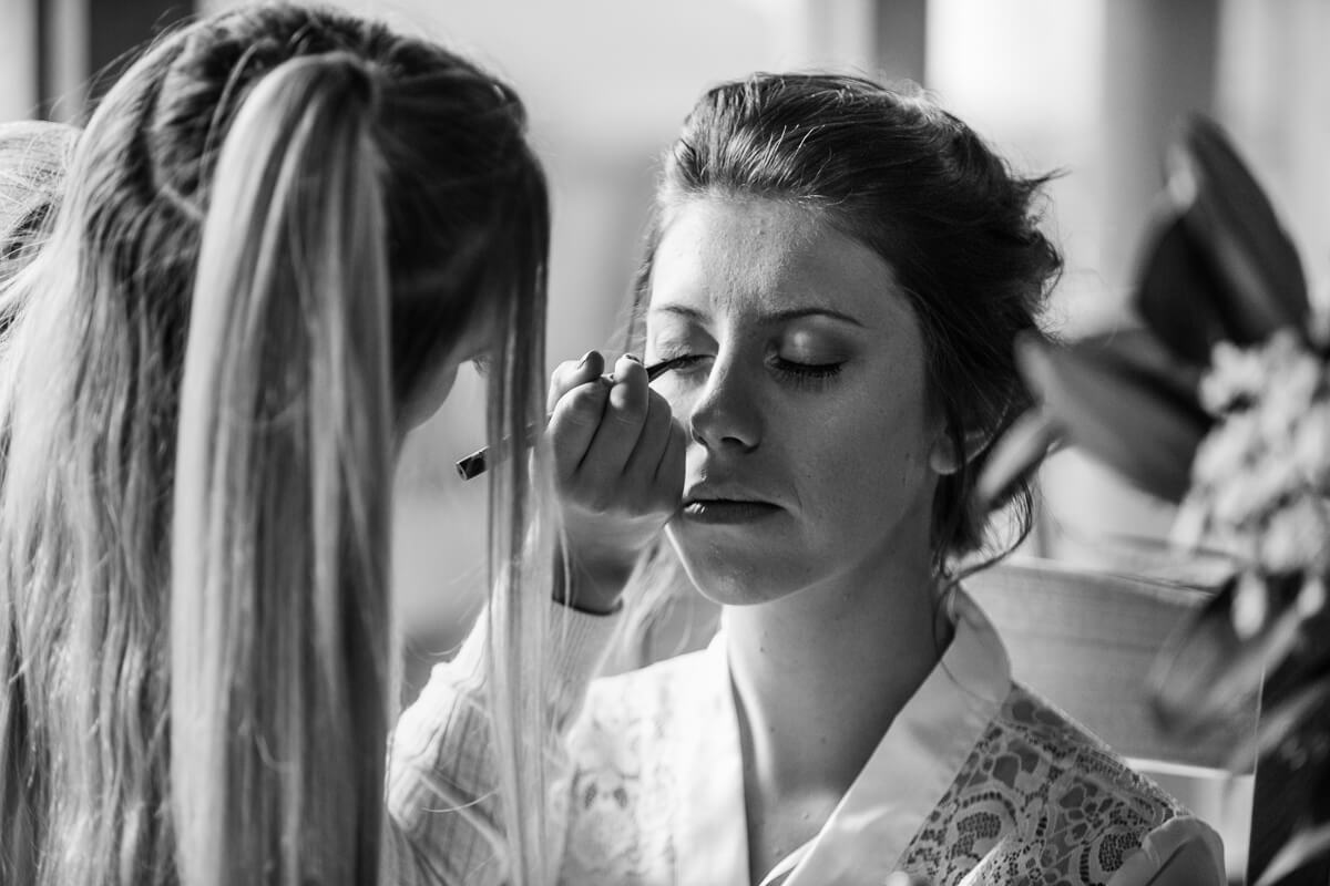 Bride having makeup applied